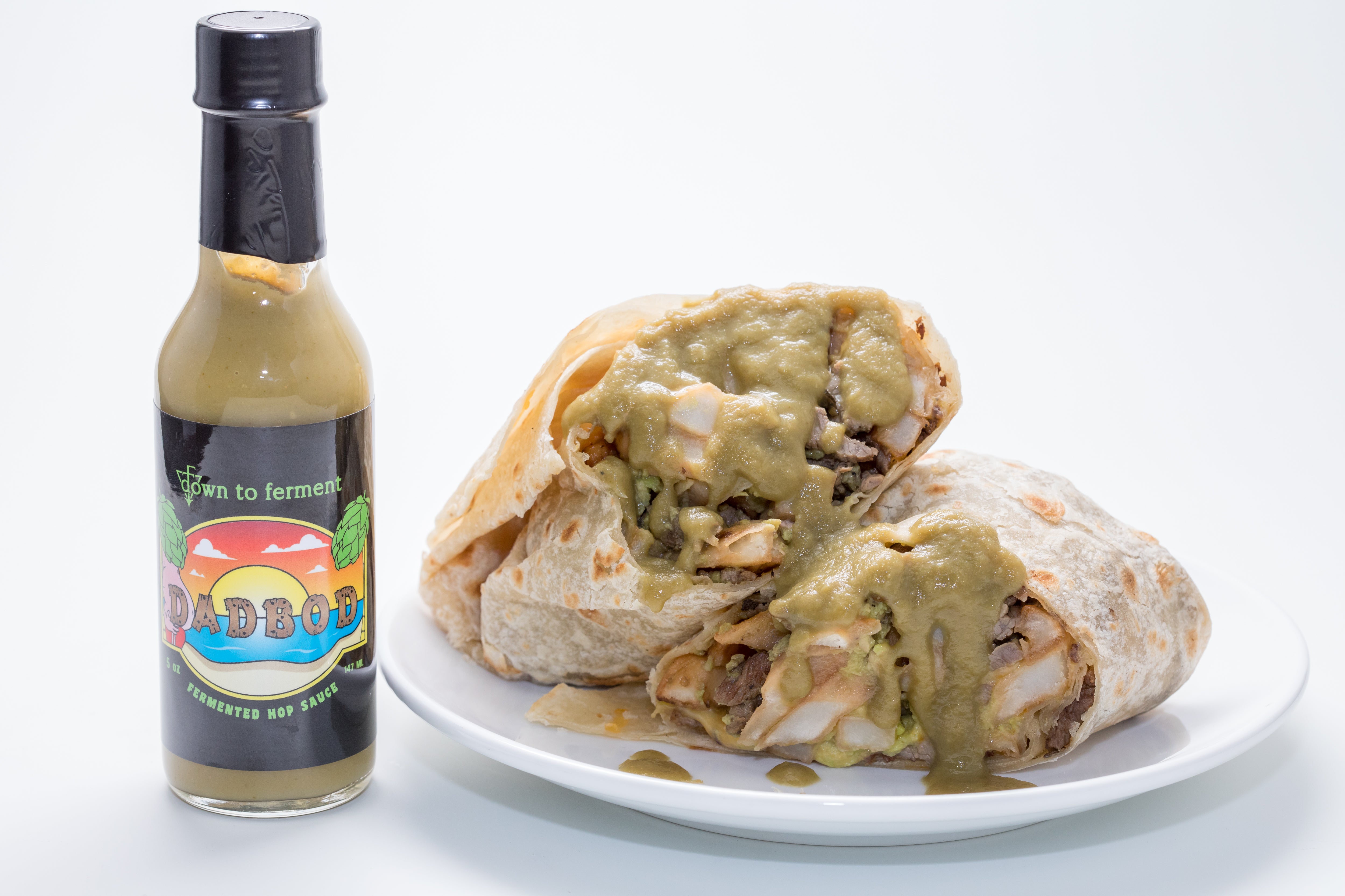 Dad Bod Hop Sauce with breakfast burritos. Fermented, Kombucha based hot sauce. Salsa verde with a twist - serrano peppers.